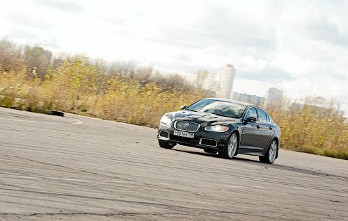 Динамический режим (включается кнопкой с клетчатым флагом у шайбы трансмиссии) мне показался не слишком полезным, так как Ягуару и так всегда хватает и мощности, и собранности, и быстродействия «коробки». Но для хардкорных «покатушек» в сочетании с отключением системы стабилизации он может и пригодиться — подвеска становится чуть жёстче, а педель газа ещё немного отзывчивее